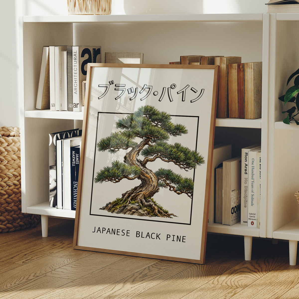 The Pine That Learned to Lean, a Japanese black pine bonsai with dark green needles and a twisted trunk in a shallow pot, in a framed Japanese travel poster style with katakana above and JAPANESE BLACK PINE below, in a wood frame on a white bookshelf beside stacked books and a small basket