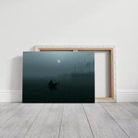 The Quiet Crossing Before Morning, a lone rowboat drifting across misty teal water beneath a pale moon, a dark forest edge behind it, on a gallery canvas with wrapped edges leaning against a white wall