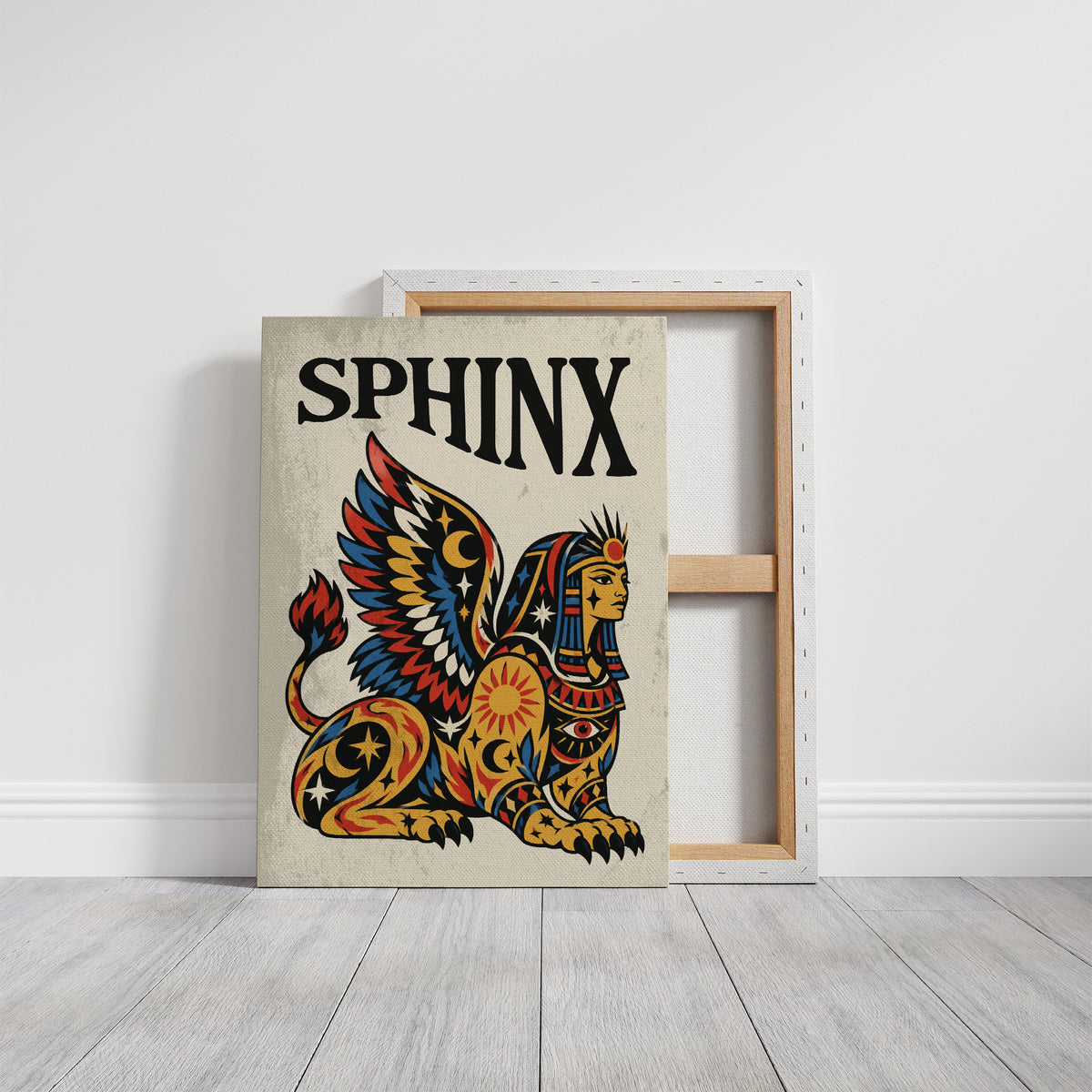 The Sphinx Keeps Her Riddle, a winged sphinx seated with folded wings in gold, red and blue, painted in bold black outlines on a cream paper ground beneath bold black lettering, in a traditional tattoo flash style, on a gallery canvas with wrapped edges leaning against a white wall