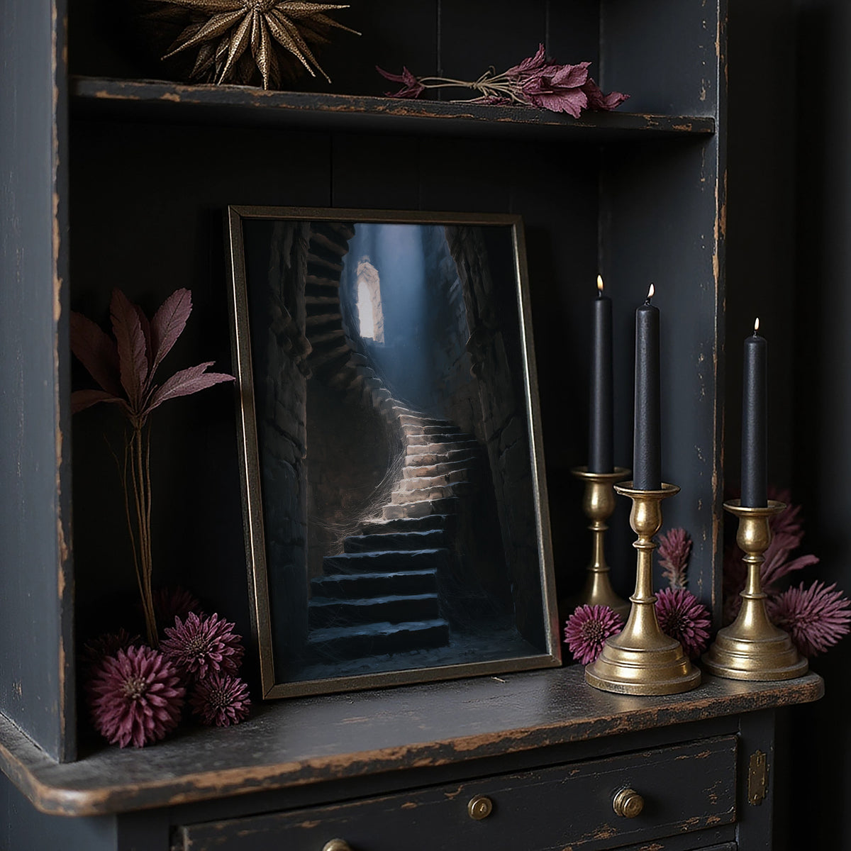 The Stairs Climb Toward Morning, narrow stone steps climbing toward a shaft of cool light painting, on a dark wooden cabinet shelf with candles and dried flowers