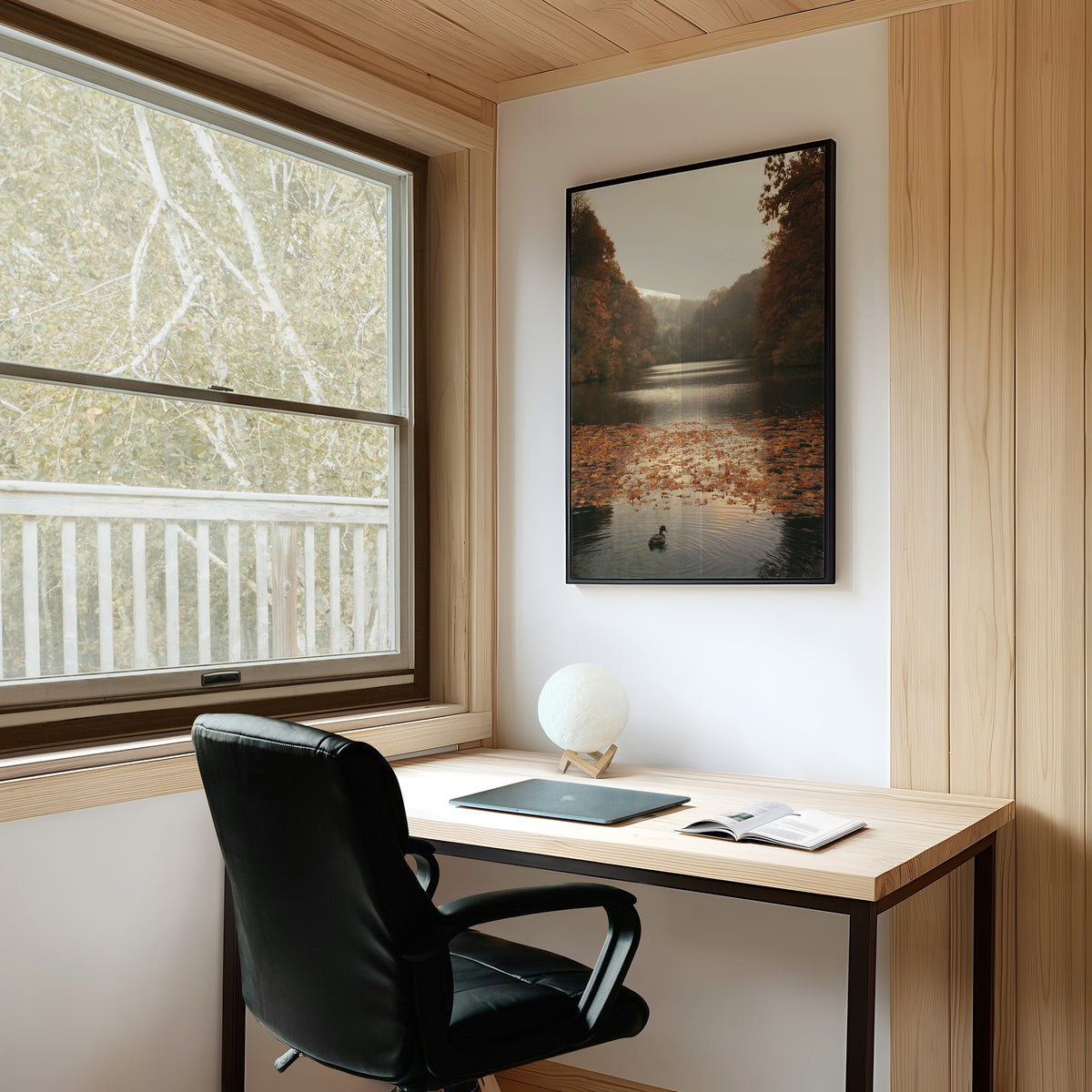 The Swan Waits on the Lake, a lone swan drifting on still water under turning autumn trees, with fallen leaves on the shore and a hazy golden light, painted in rust, amber and soft slate, on a study wall above a writing desk and a black desk chair