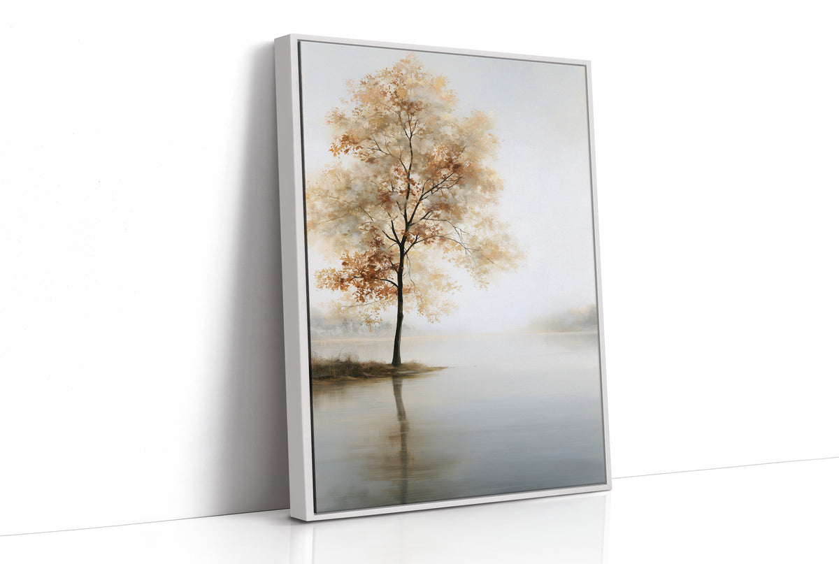 The Tree Stays Put in the Mist, a single tree with autumn gold in its crown standing on the edge of a pale lake, with the mist rolling low over the water and the sky a soft cream and blue, as a framed canvas in a white frame