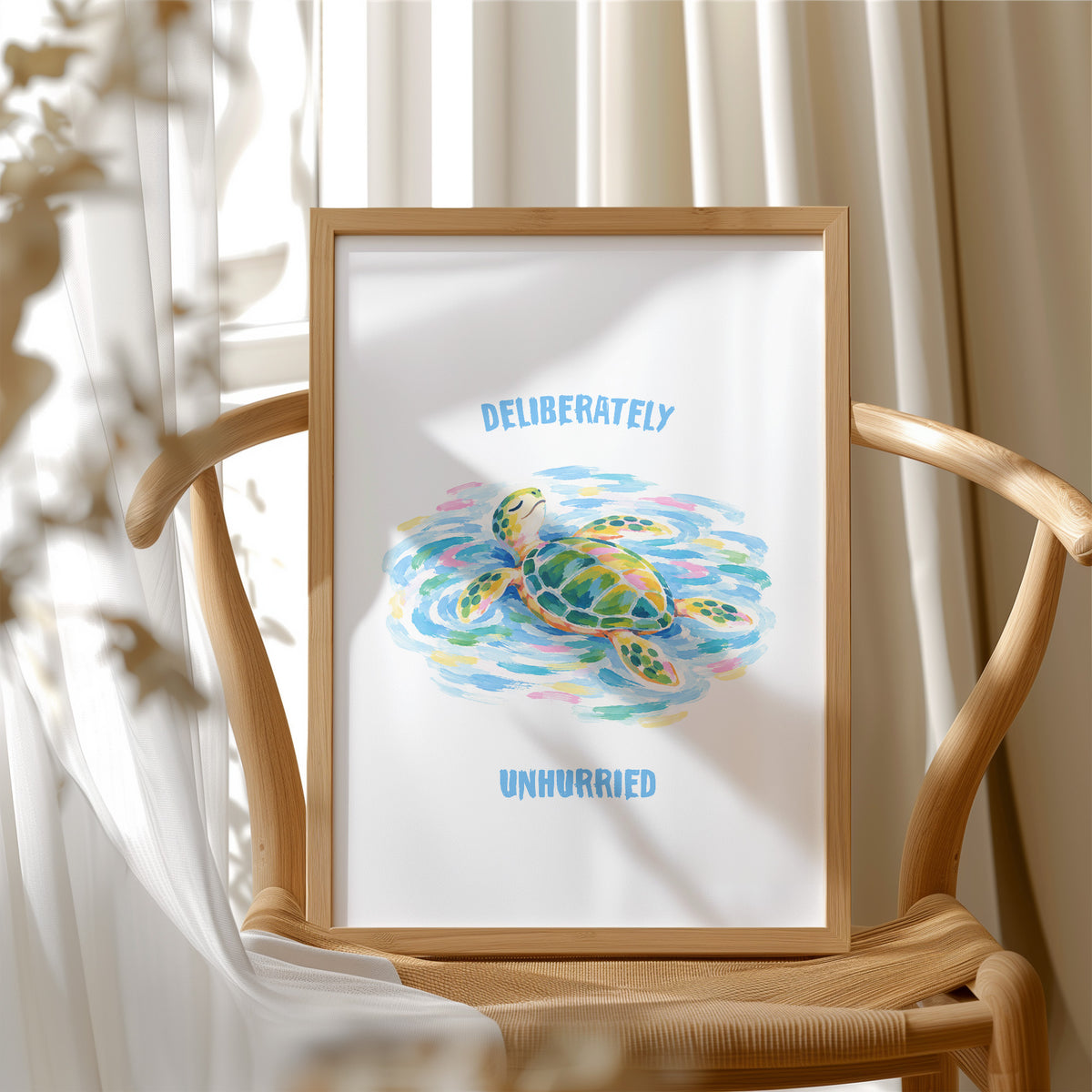 The Turtle Keeps Its Own Time, a sea turtle drifting over pale blue and green watercolor waves, with two lines of bold blue lettering above and below it on a white ground, in a soft watercolor style, in a wood frame beside a wicker chair by a sunny window