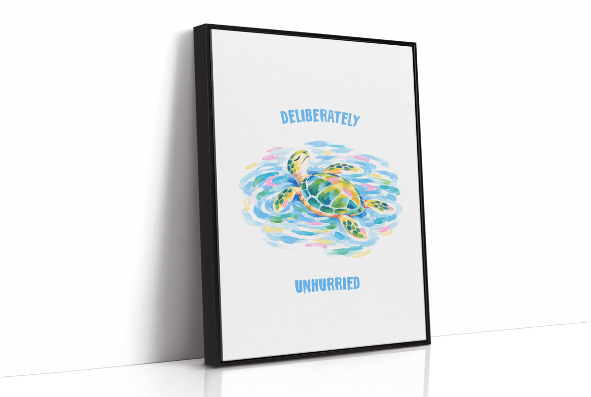 The Turtle Keeps Its Own Time, a sea turtle drifting over pale blue and green watercolor waves, with two lines of bold blue lettering above and below it on a white ground, in a soft watercolor style, as a framed canvas in a black frame