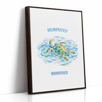 The Turtle Keeps Its Own Time, a sea turtle drifting over pale blue and green watercolor waves, with two lines of bold blue lettering above and below it on a white ground, in a soft watercolor style, as a framed canvas in a brown frame