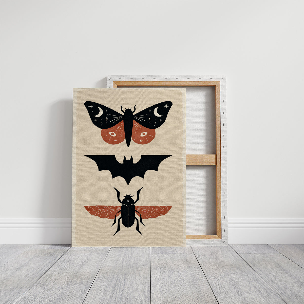 Three Night Visitors in a Row, a moth with crescent moon spots, a black bat in flight and a beetle with rust wings stacked in a column on a cream ground, painted in black, rust and cream, on a gallery canvas with wrapped edges leaning against a white wall
