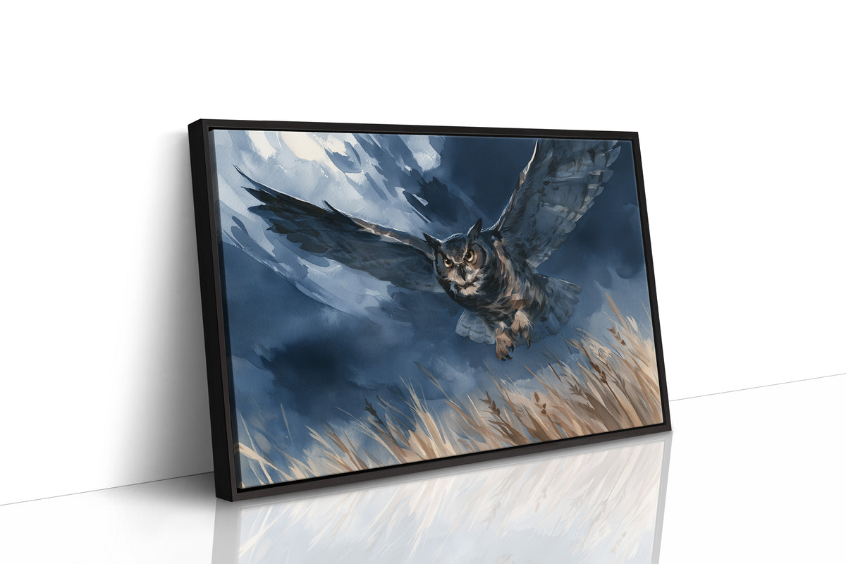Through the Storm on Silent Wings, an owl in flight low over golden grass beneath a blue and cloud dark storm sky, as a framed canvas in a black frame
