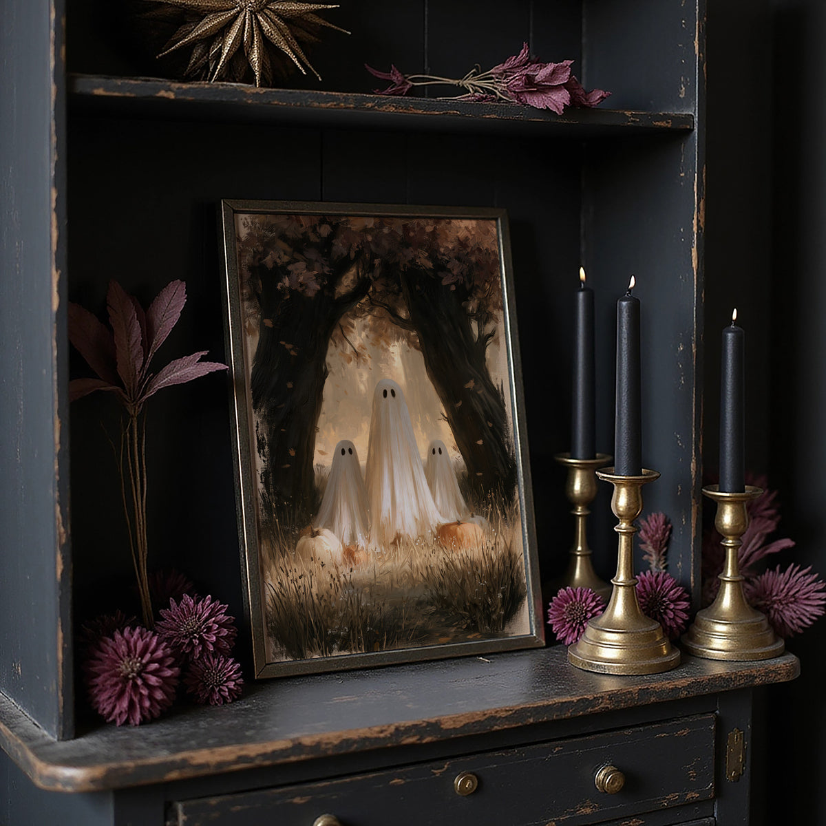 Two Visitors Under the Arch, two pale ghosts standing under an arch of dark trees above a field of tall grass and fallen leaves, painted in deep brown, bone and moss, in a dark frame on a black shelf beside brass candles and dried leaves