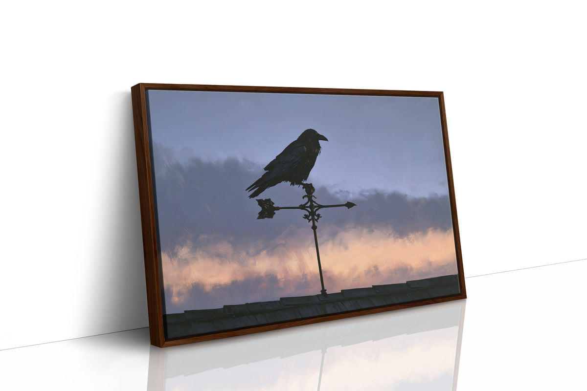 Watcher on the Weathervane, a black raven perched on a weathervane against a dusk sky banded in dusky blue and rose, as a framed canvas in a brown frame