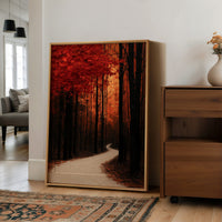Where the Crimson Path Bends, a winding forest path through tall dark trunks under a blaze of red canopy, painted in deep crimson, russet and warm shadow, in a wood frame on a wall beside a walnut cabinet and an open doorway