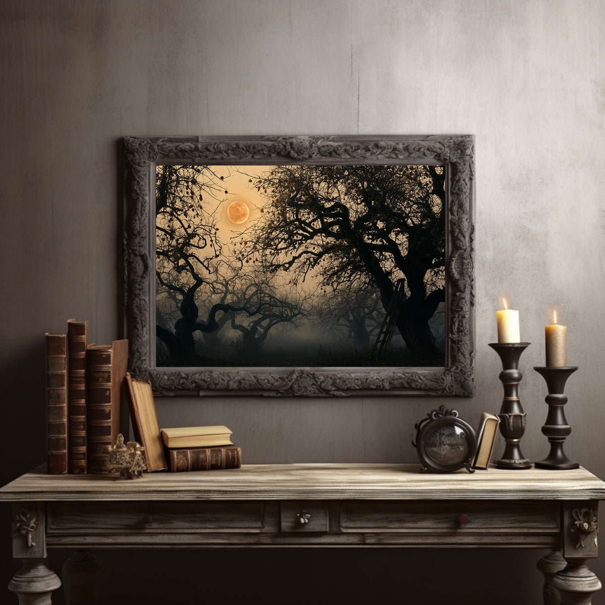 Where the Old Oak Keeps Watch, a bare twisted tree silhouetted against an amber full moon above a misty dark forest, in a dark carved frame on a gray wall above a console table with candlesticks and old books