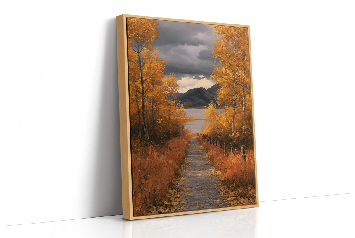 Where the Storm Lets Go of the Lane, a dirt lane between gold birches toward soft mountains under a clearing gray sky, painted in amber, slate and rust, as a framed canvas in a natural wood frame
