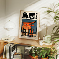 Where the Tide Meets the Posts, a vermilion torii shrine gate standing in shallow teal water beneath a bright orange sun, in a flat Japanese travel poster style with bold black lettering, painted in vermilion, teal and cream, in a wood frame on a console table beside a white lamp and stacked books