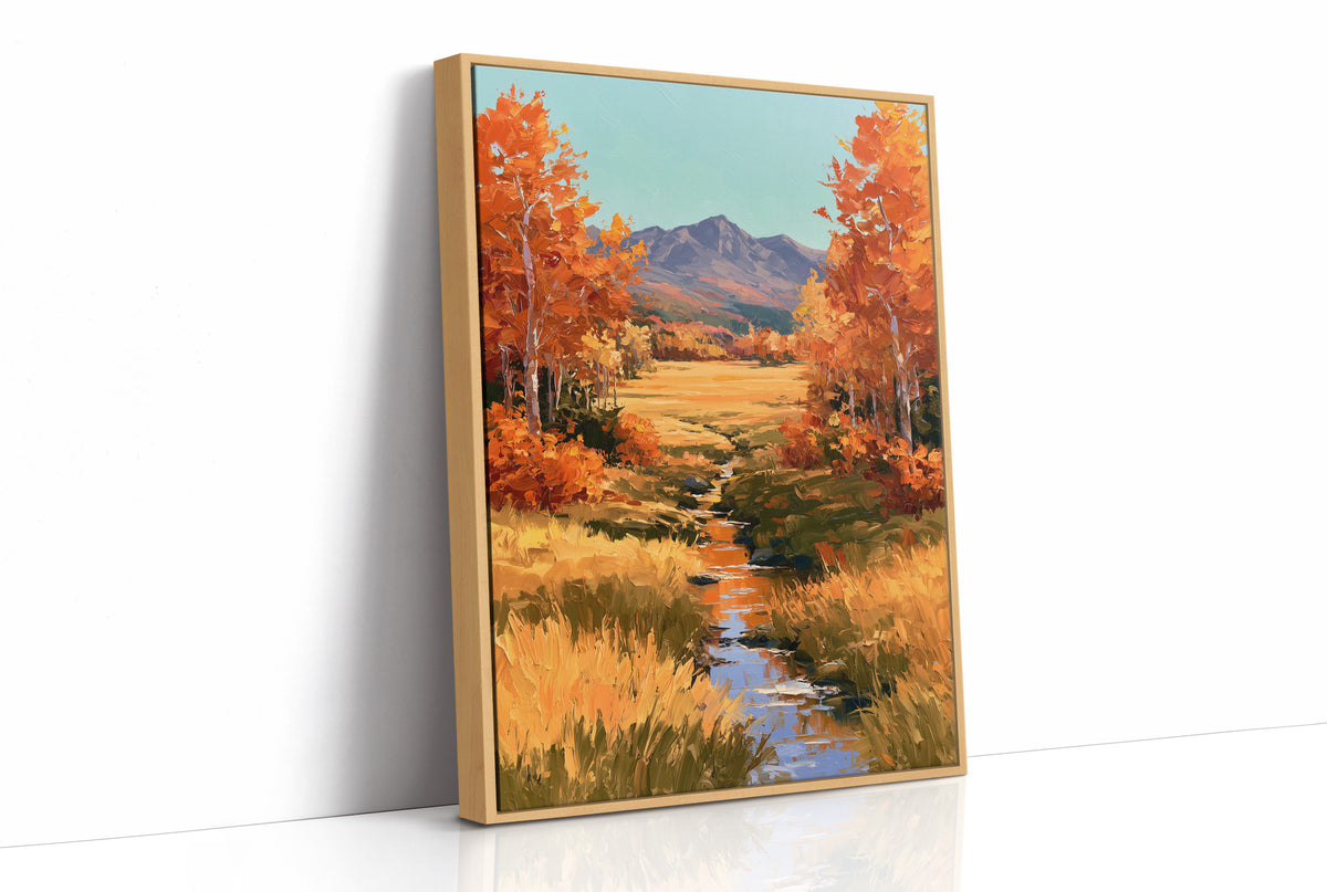 Where the Valley Turns Amber, an autumn valley of aspen trees in amber and rust beside a winding creek, with blue mountains and a pale sky above, painted in amber, rust and sky blue, as a framed canvas in a natural wood frame