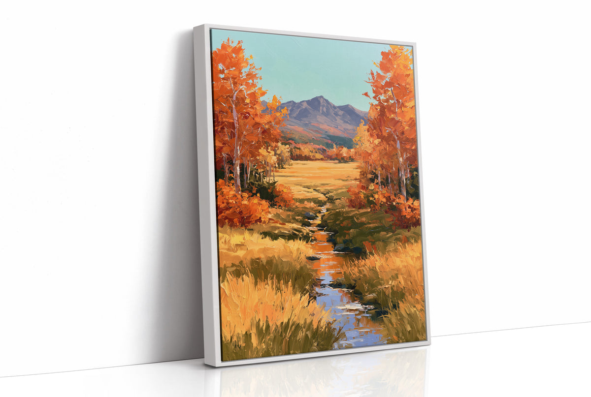 Where the Valley Turns Amber, an autumn valley of aspen trees in amber and rust beside a winding creek, with blue mountains and a pale sky above, painted in amber, rust and sky blue, as a framed canvas in a white frame