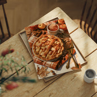 Lattice Get This Pie Started, print laid on a wooden table beside a white mug and flowers