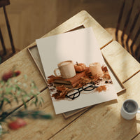 Read Between The Latte Lines, print laid on a wooden table beside a white mug and flowers