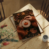 Hoop Dreams, Pumpkin Edition, print laid on a wooden table beside a white mug and flowers