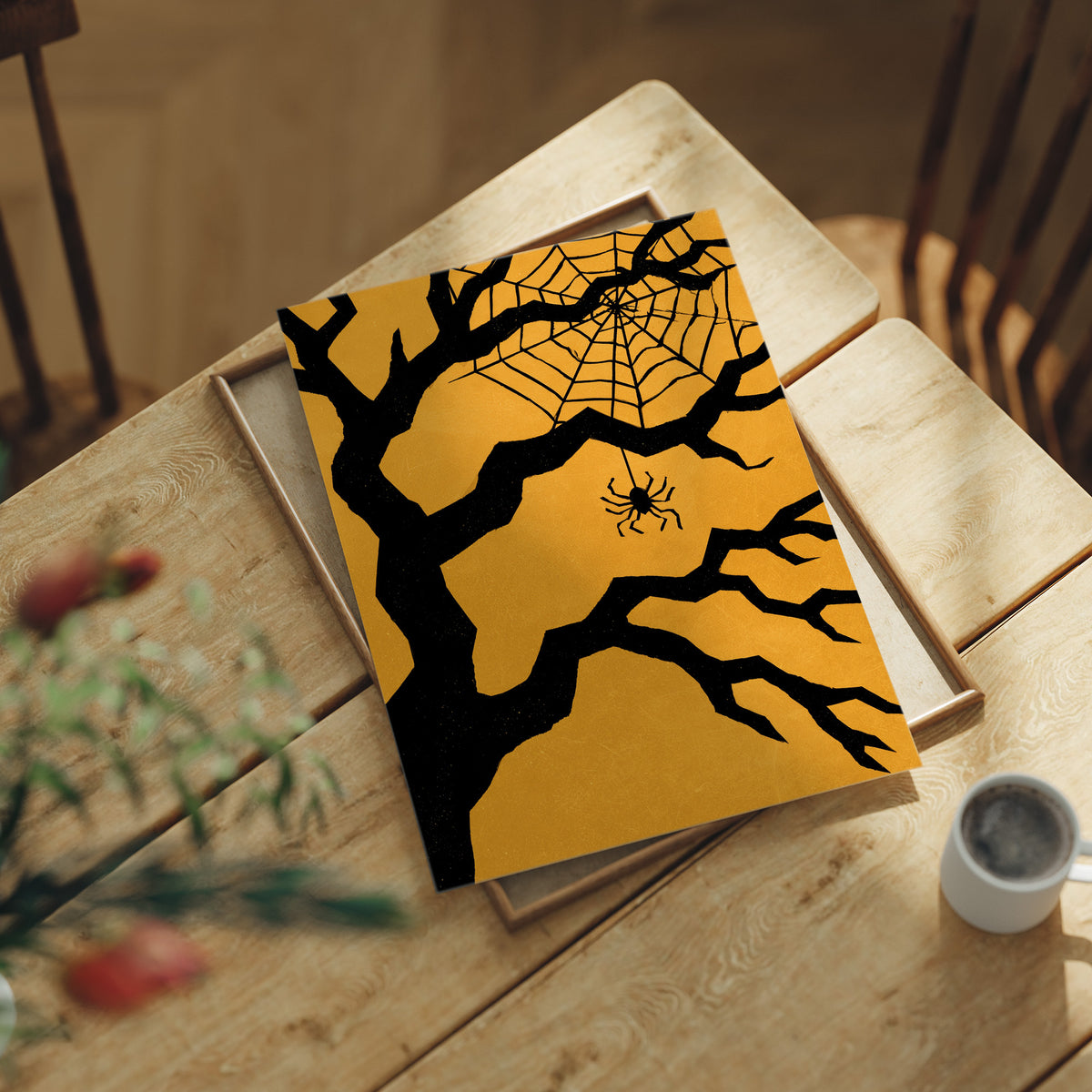Just Hanging Around, Spookily, print laid on a wooden table beside a white mug and flowers