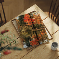 Seeing Red, Reflecting Well, print laid on a wooden table beside a white mug and flowers