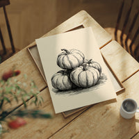 Top Gourd Takes The High Ground, print laid on a wooden table beside a white mug and flowers