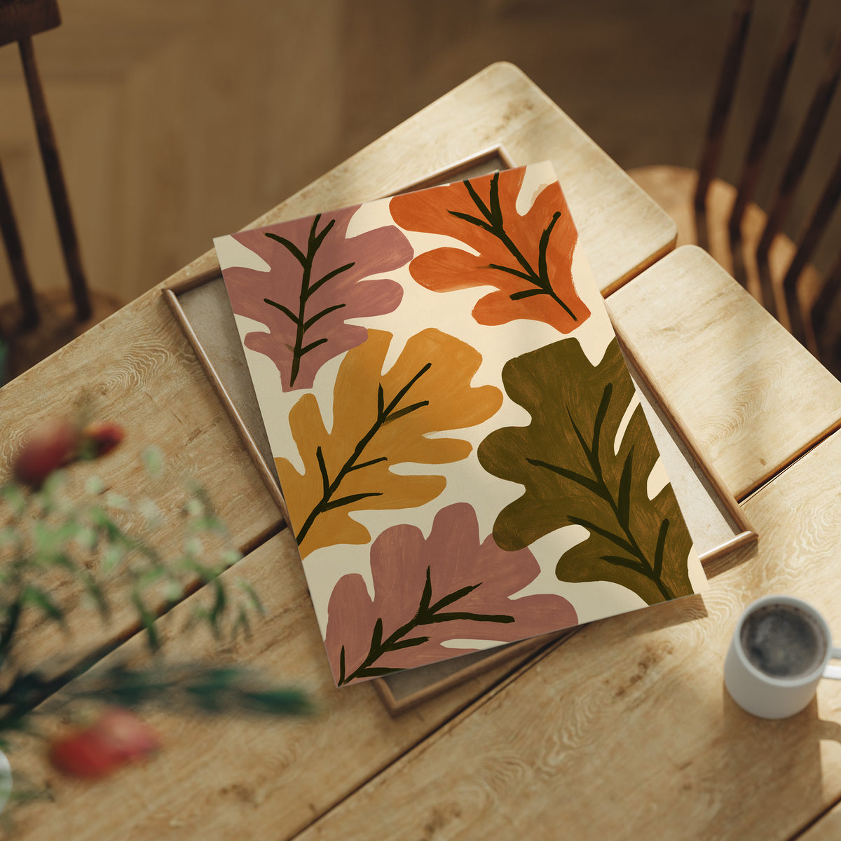Big Leaf Energy, print laid on a wooden table beside a white mug and flowers