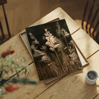 Plume With A View, print laid on a wooden table beside a white mug and flowers