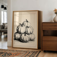 Gourd Squad, Stacked And Unbothered, large framed print leaning on a white wall beside a wood cabinet