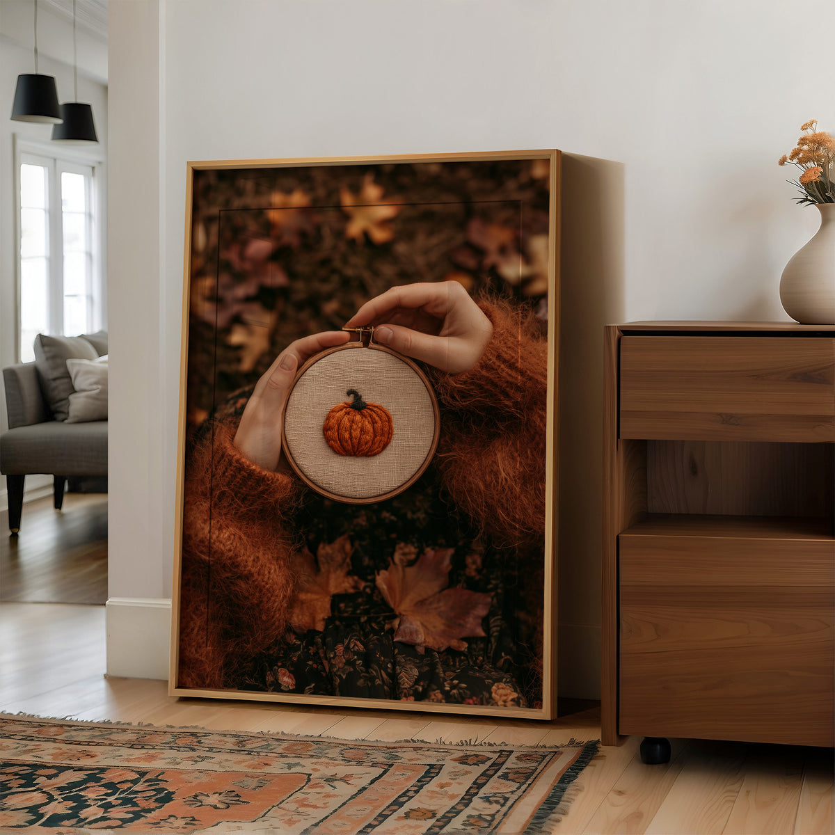 Hoop Dreams, Pumpkin Edition, large framed print leaning on a white wall beside a wood cabinet