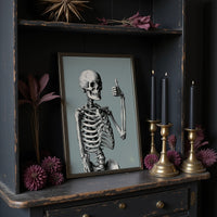 Bone Voyage, You’ve Got This, large framed print leaning on a white wall beside a wood cabinet