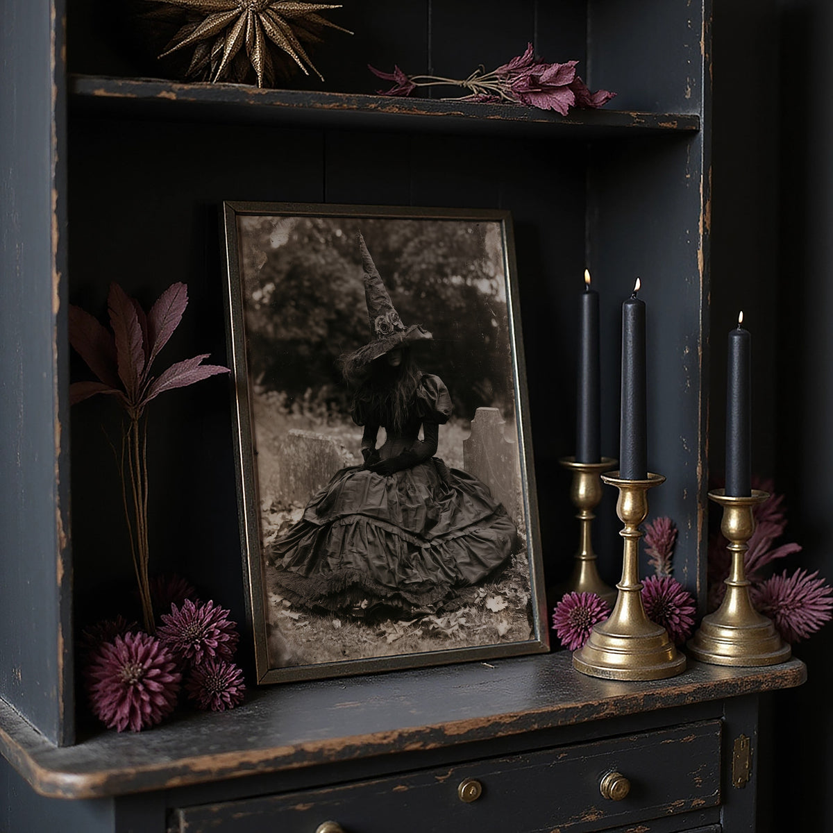 Resting Witch Face, large framed print leaning on a white wall beside a wood cabinet
