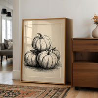 Top Gourd Takes The High Ground, large framed print leaning on a white wall beside a wood cabinet