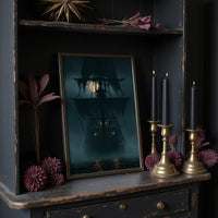 Ghost Ship Arriving Fashionably Late, large framed print leaning on a white wall beside a wood cabinet