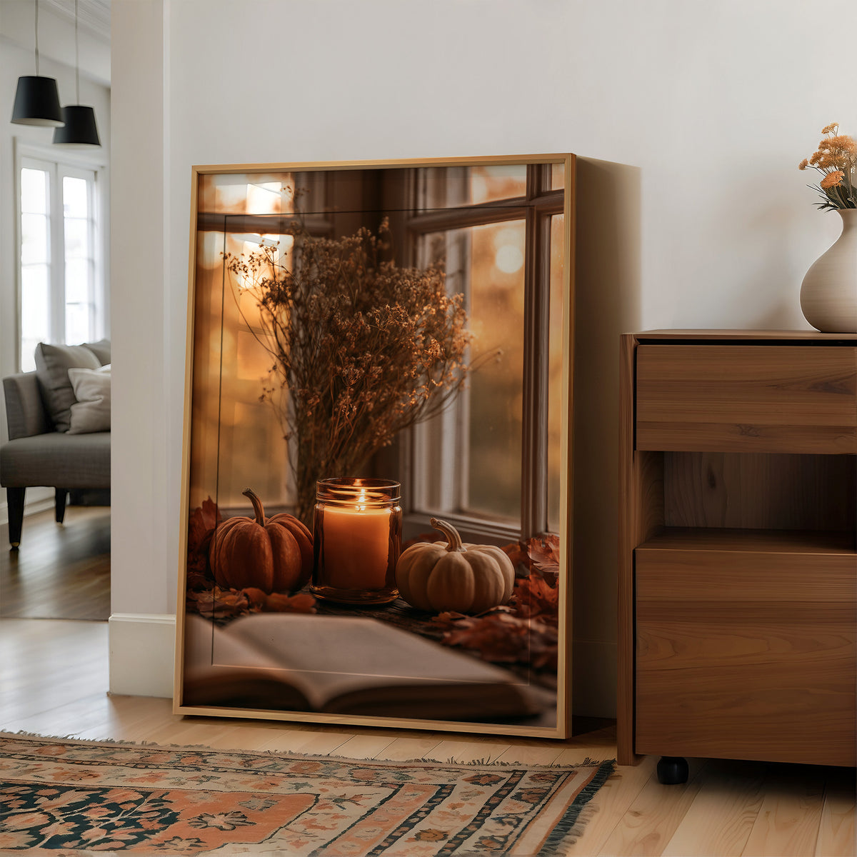 Candle Lit, Chapter Pending, large framed print leaning on a white wall beside a wood cabinet