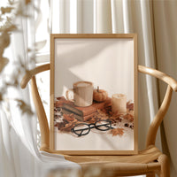 Read Between The Latte Lines, framed print resting on a wooden chair beside sheer curtains