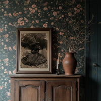 Resting Witch Face, framed print resting on a wooden chair beside sheer curtains
