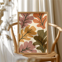 Big Leaf Energy, framed print resting on a wooden chair beside sheer curtains